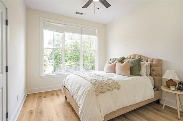 bedroom with light wood-type flooring and ceiling fan