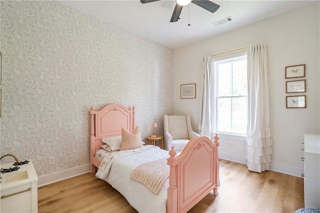 bedroom with ceiling fan and light wood-type flooring