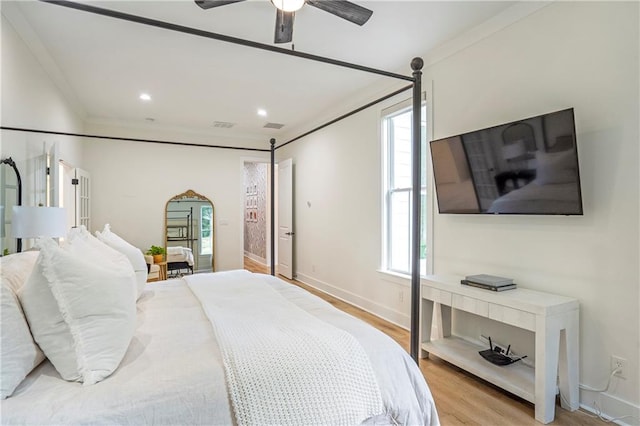 bedroom with ornamental molding, light hardwood / wood-style flooring, and ceiling fan