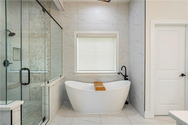 bathroom featuring tile walls and shower with separate bathtub