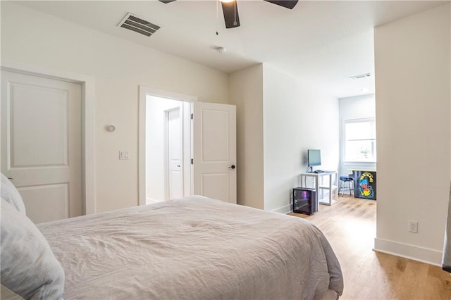 bedroom with light hardwood / wood-style flooring and ceiling fan