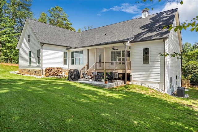 rear view of property featuring a patio, central AC, a lawn, and ceiling fan