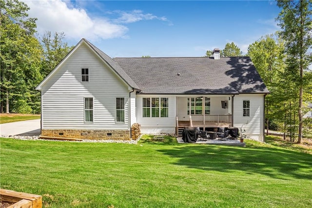 rear view of property with a yard