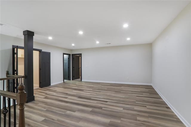 spare room featuring visible vents, recessed lighting, baseboards, and wood finished floors