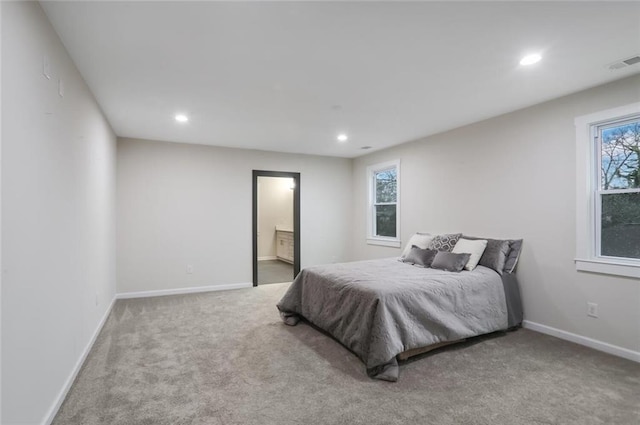 bedroom with baseboards, visible vents, carpet floors, recessed lighting, and ensuite bathroom