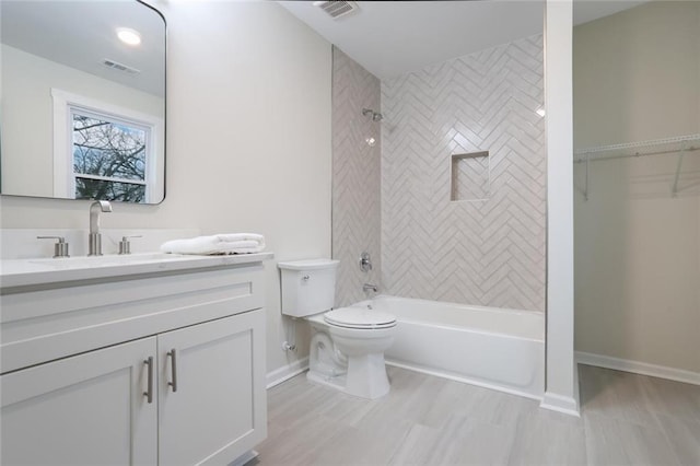 bathroom with visible vents, tub / shower combination, toilet, and vanity