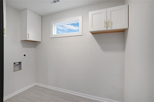 laundry room featuring visible vents, cabinet space, hookup for an electric dryer, and baseboards