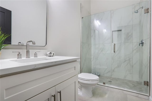 bathroom featuring a marble finish shower, toilet, and vanity