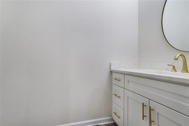 bathroom featuring baseboards and vanity