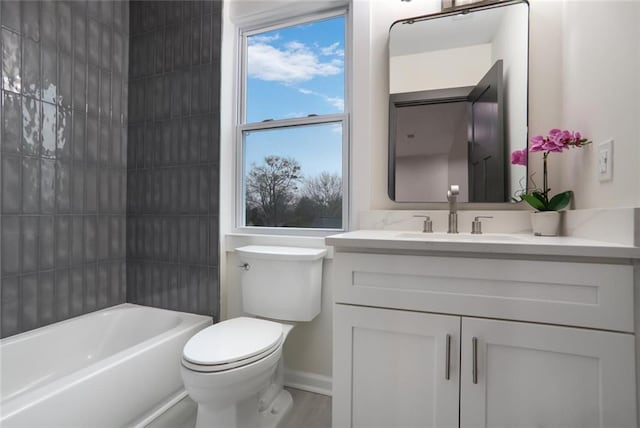 full bath featuring vanity, toilet, and baseboards