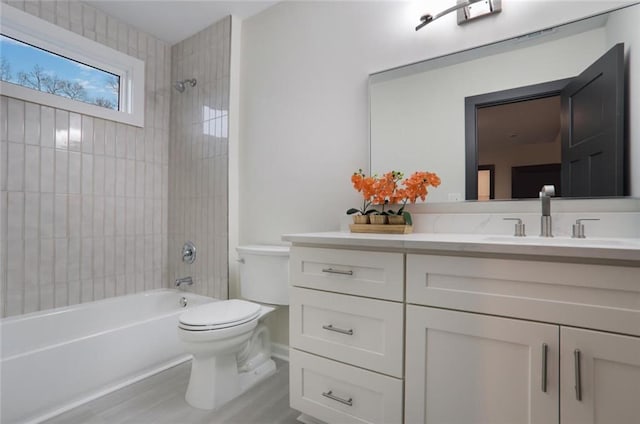 full bathroom featuring bathing tub / shower combination, toilet, and vanity