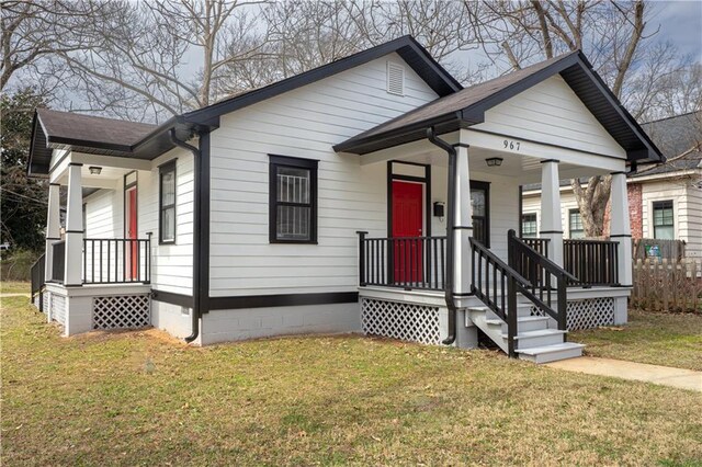 view of front of home with covered porch and a front yard