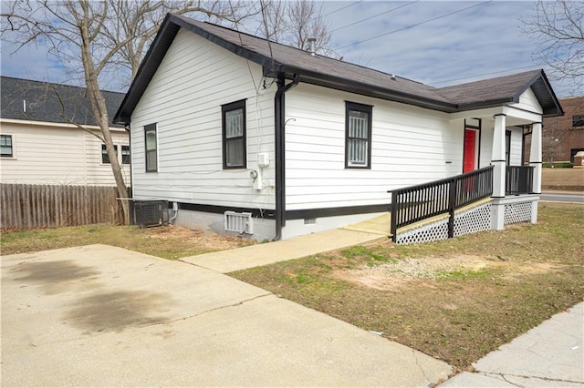 view of front of home with crawl space, fence, and central air condition unit