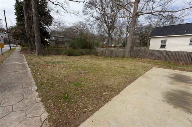 view of yard with fence and a patio