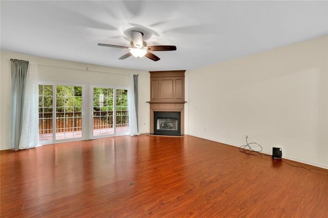 3443 Lathenview Ct, Alpharetta, GA 30004 - unfurnished living room featuring wood finished floors, ceiling fan, and a fireplace