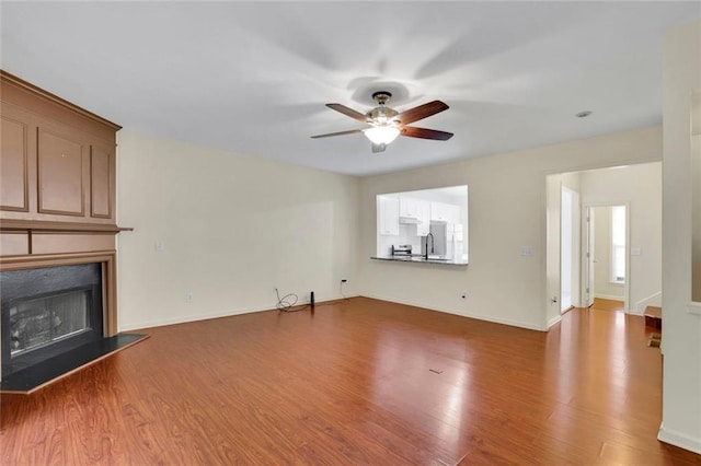 3443 Lathenview Ct, Alpharetta, GA 30004 - unfurnished living room with ceiling fan, wood finished floors, and a fireplace with raised hearth
