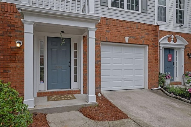 3443 Lathenview Ct, Alpharetta, GA 30004 - view of exterior entry with concrete driveway, brick siding, and a garage