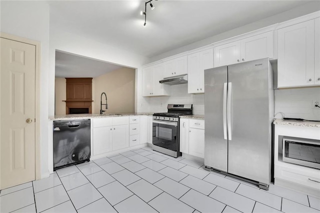 3443 Lathenview Ct, Alpharetta, GA 30004 - kitchen featuring appliances with stainless steel finishes, under cabinet range hood, tasteful backsplash, and white cabinetry