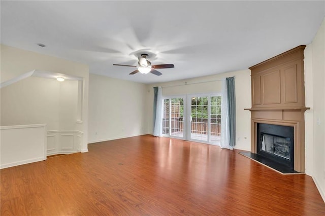 3443 Lathenview Ct, Alpharetta, GA 30004 - unfurnished living room featuring wood finished floors, a ceiling fan, and a large fireplace