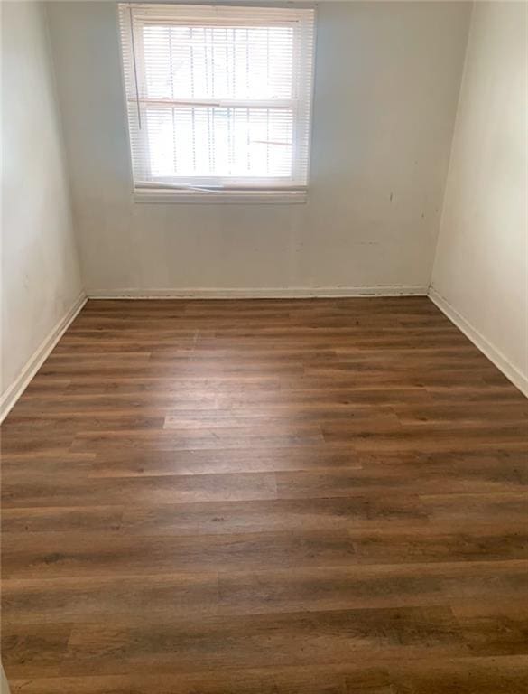 unfurnished room with dark hardwood / wood-style floors