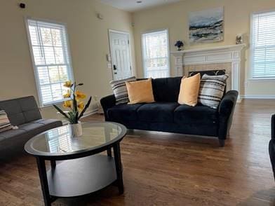 737 Cooper St SW, Atlanta, GA 30315 - living room with wood finished floors, baseboards, and a fireplace