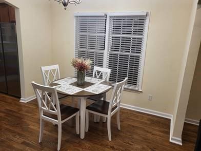 737 Cooper St SW, Atlanta, GA 30315 - dining space with a chandelier, baseboards, and wood finished floors