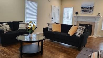 737 Cooper St SW, Atlanta, GA 30315 - living room featuring wood finished floors, baseboards, and a fireplace