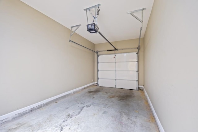garage with baseboards and a garage door opener
