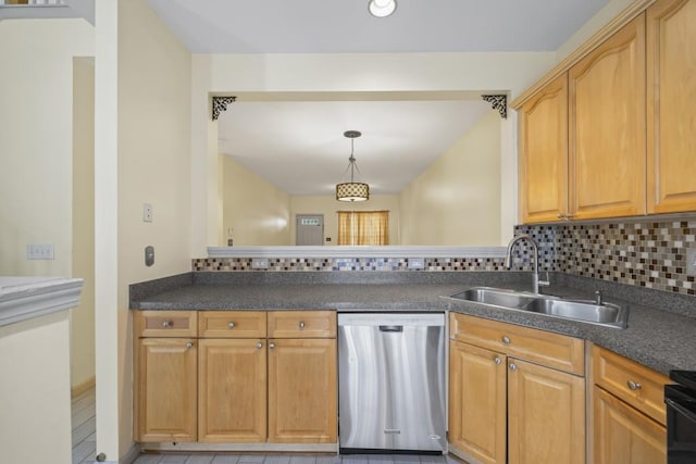 kitchen with a sink, decorative backsplash, dishwasher, and dark countertops