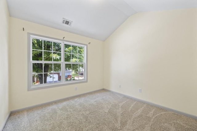 unfurnished room featuring vaulted ceiling, visible vents, baseboards, and carpet
