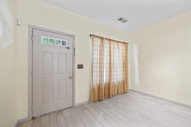 foyer entrance with baseboards, visible vents, and light wood-style floors