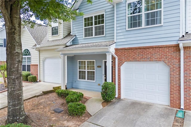 view of front facade with concrete driveway, brick siding, and a garage