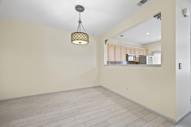 unfurnished room featuring recessed lighting, baseboards, light wood-type flooring, and visible vents