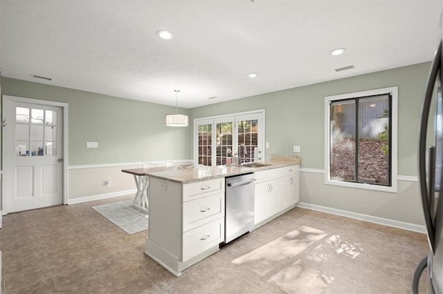 kitchen featuring light stone countertops, dishwasher, pendant lighting, white cabinetry, and sink