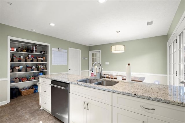 kitchen with white cabinets, light stone countertops, pendant lighting, sink, and stainless steel dishwasher