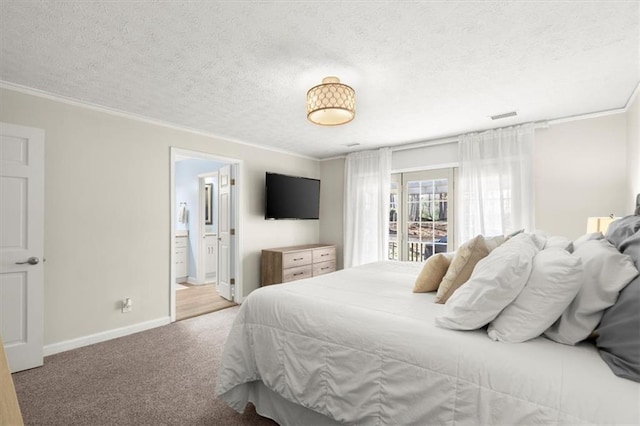 bedroom featuring a textured ceiling, light carpet, ornamental molding, and ensuite bath