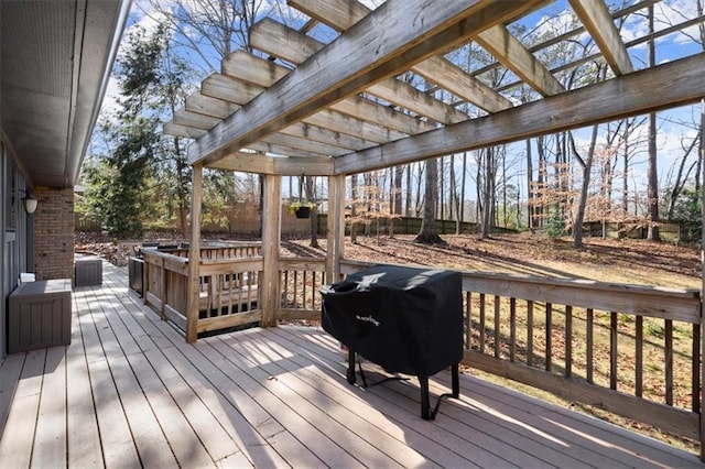 wooden deck featuring a pergola and area for grilling