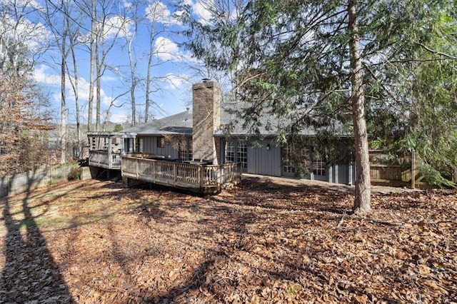 rear view of house featuring a wooden deck