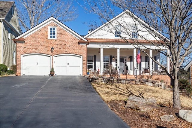 view of front facade featuring a porch and a garage