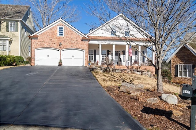 view of property featuring covered porch and a garage