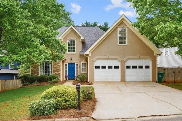 traditional home featuring roof with shingles, fence, concrete driveway, stucco siding, and a front lawn