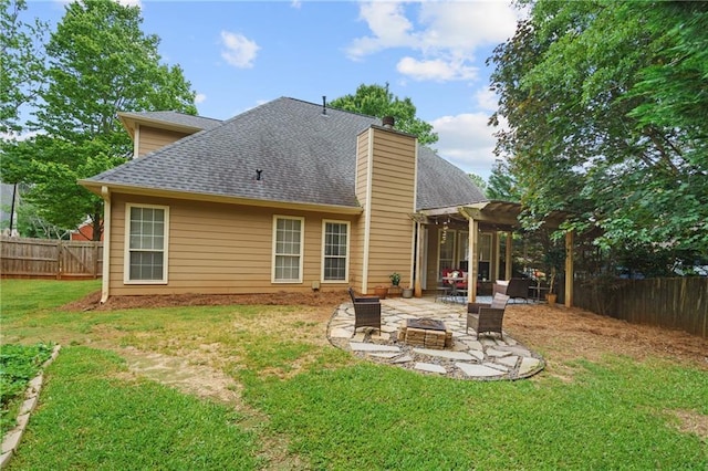 rear view of property featuring a patio area, a pergola, a shingled roof, and a fenced backyard