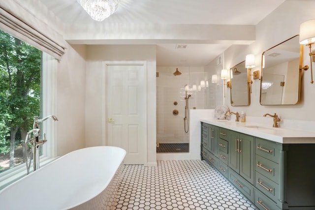 bathroom with double vanity, a soaking tub, a stall shower, and a sink