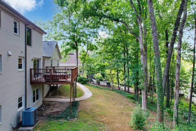 view of yard featuring cooling unit and a wooden deck