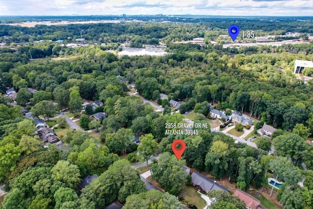 birds eye view of property featuring a view of trees