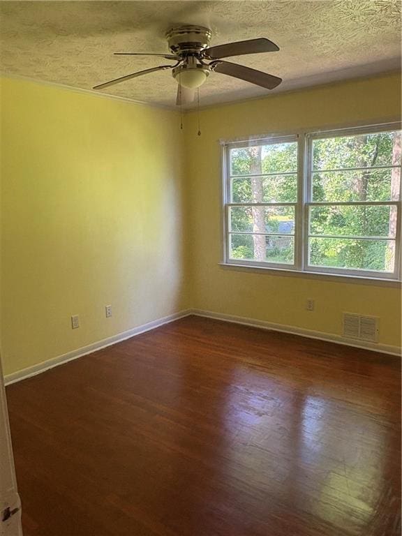 801 Needle Rock Dr, Stone Mountain, GA 30083 - unfurnished room featuring dark wood-style floors, ceiling fan, a textured ceiling, and baseboards