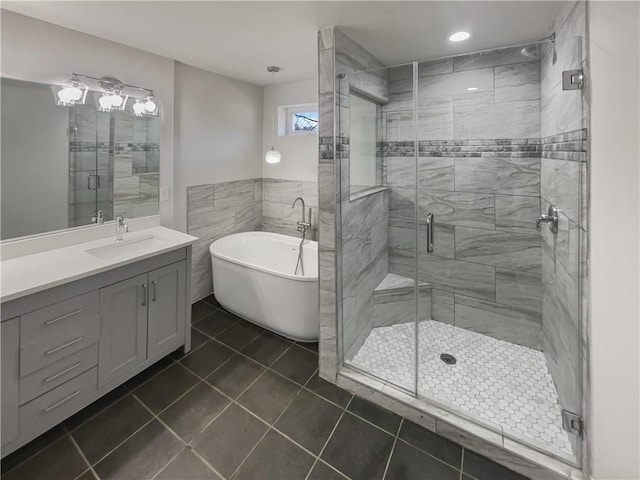 bathroom featuring a soaking tub, tile patterned floors, vanity, and a stall shower