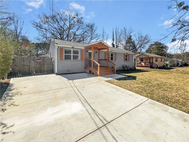 view of front facade with driveway, crawl space, fence, and a front yard