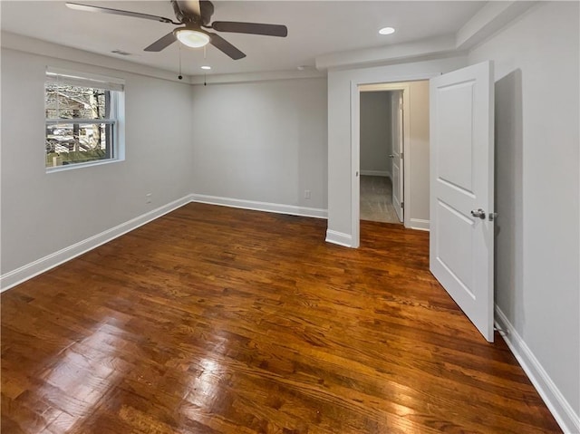 spare room with recessed lighting, wood finished floors, a ceiling fan, and baseboards