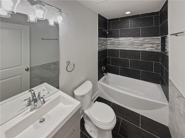 full bath featuring tub / shower combination, vanity, and toilet